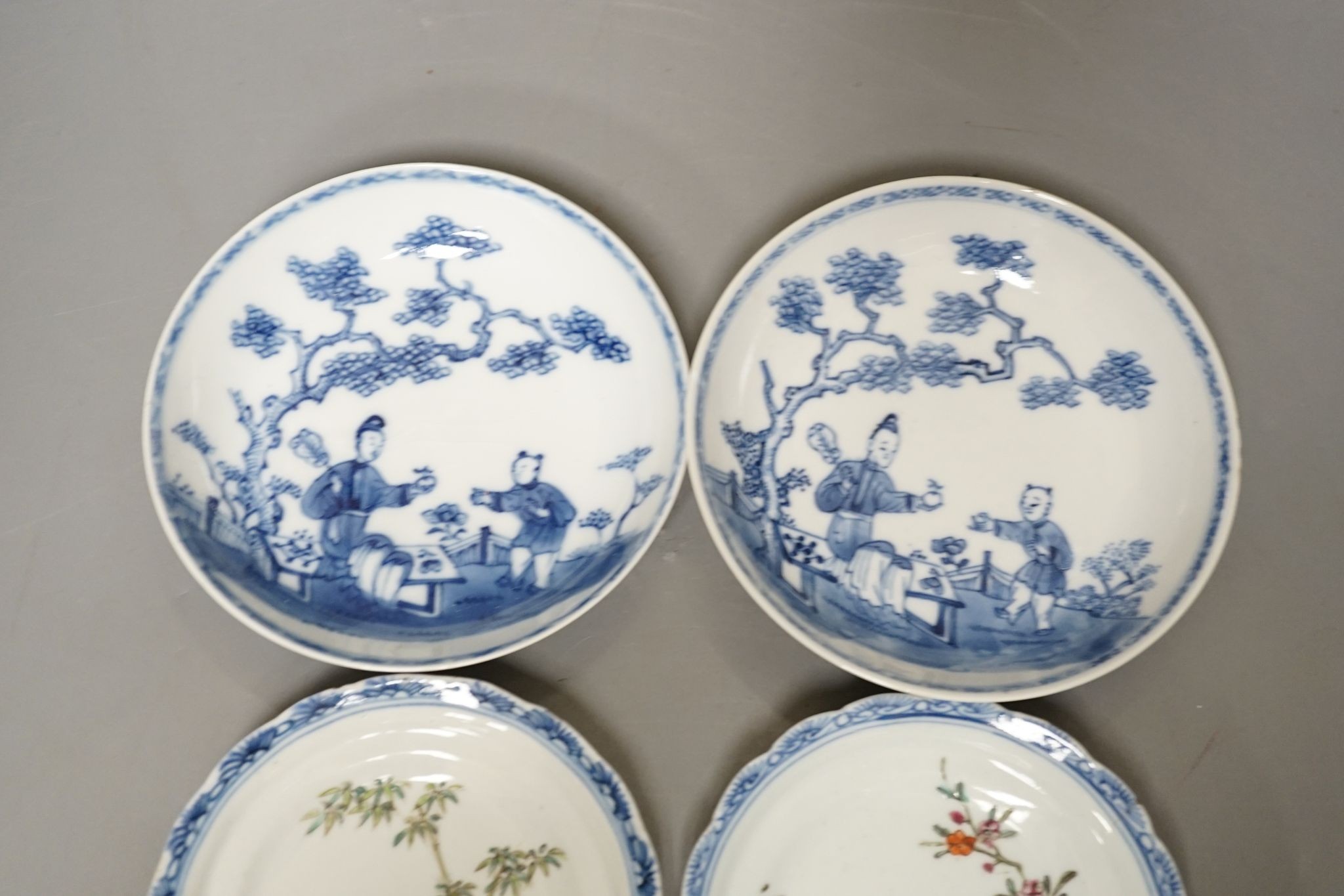 Seven 18th century Chinese saucer dishes, largest 14 cms diameter.